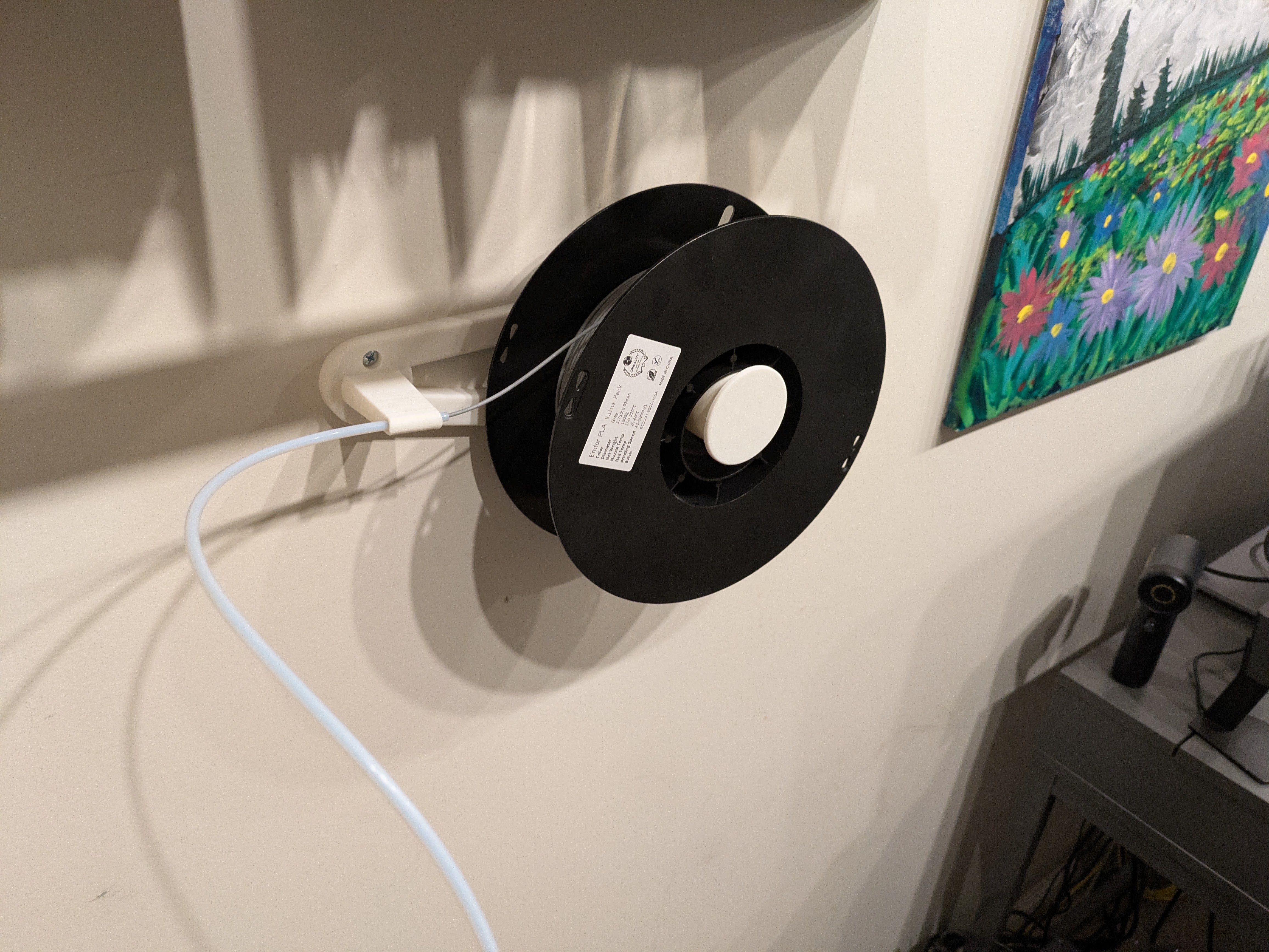 My first attempt worked really well, but I realized that the angle the filament would make going into the bowden tube would be sharp when the filament spool was full. This system did introduce more drag, so I want to avoid making that worse by using a suboptimal feed angle.