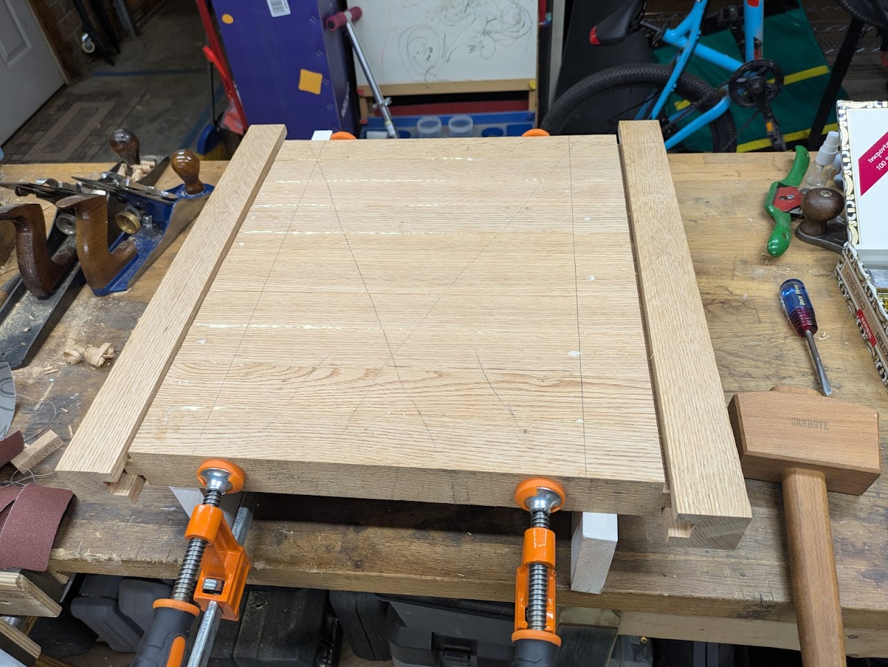 An image of my table top as it’s being glued together and clamped.